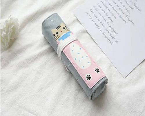 Rolling pencil case with grass green cat pattern on a school desk