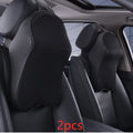 Memory foam car neck pillow with ergonomic shape, adjustable strap, and polyester cover on a car seat
