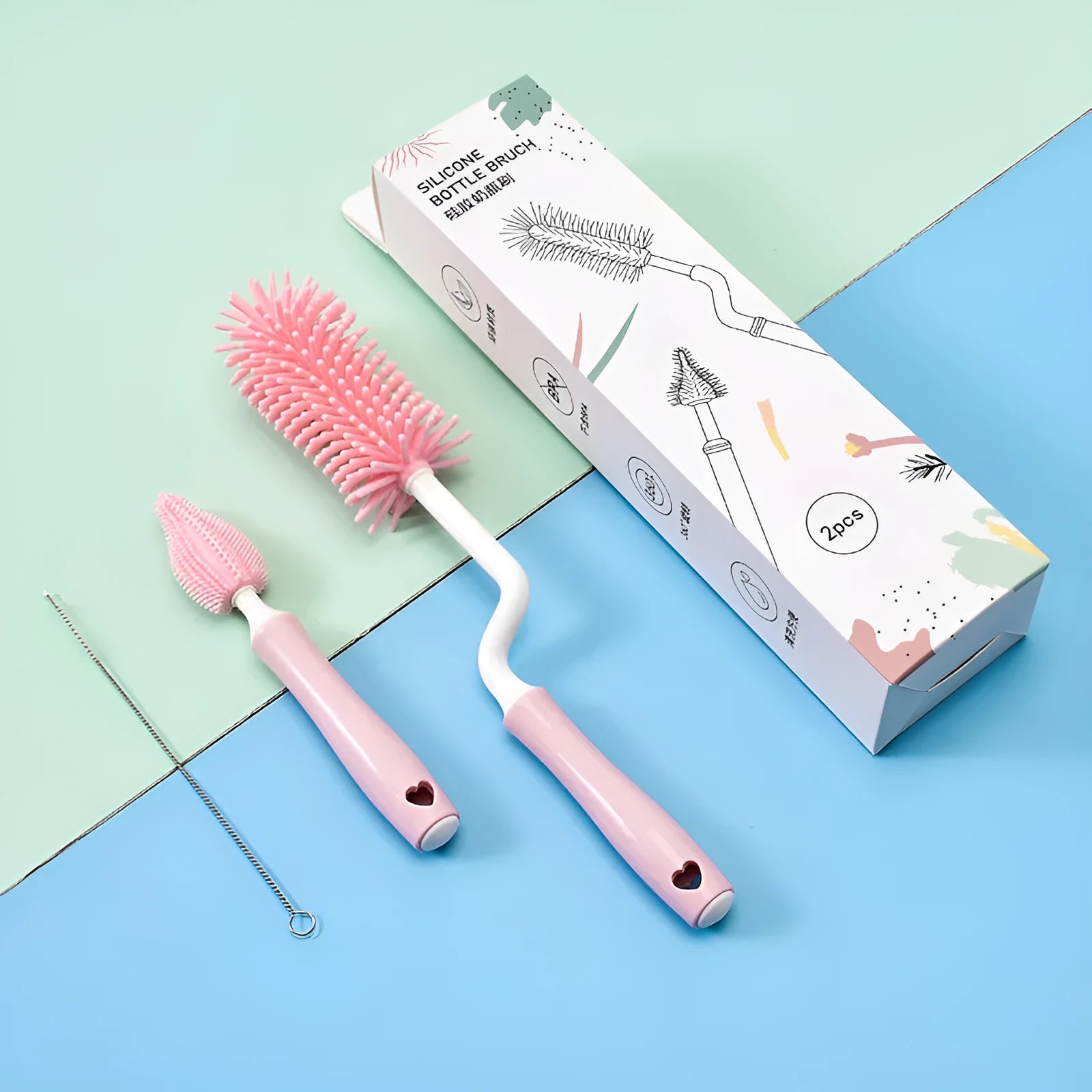Silicone baby bottle brush set with main brush and separate straw cleaner in pink, blue and yellow colours.