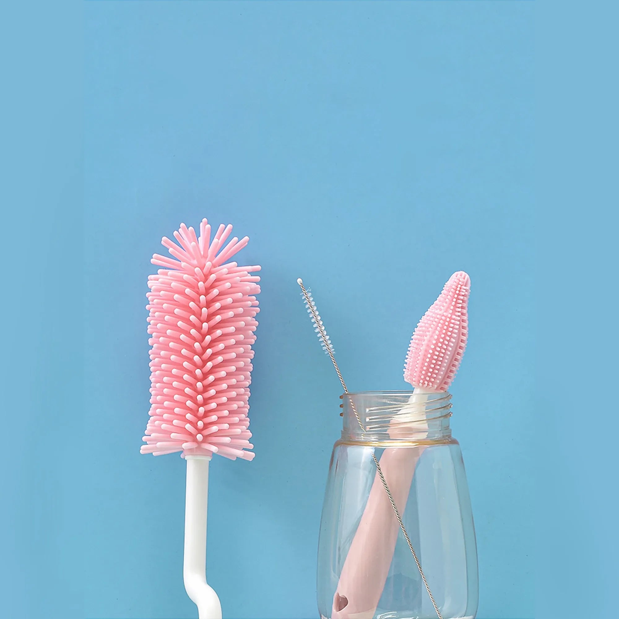 Silicone baby bottle brush set with main brush and separate straw cleaner in pink, blue and yellow colours.