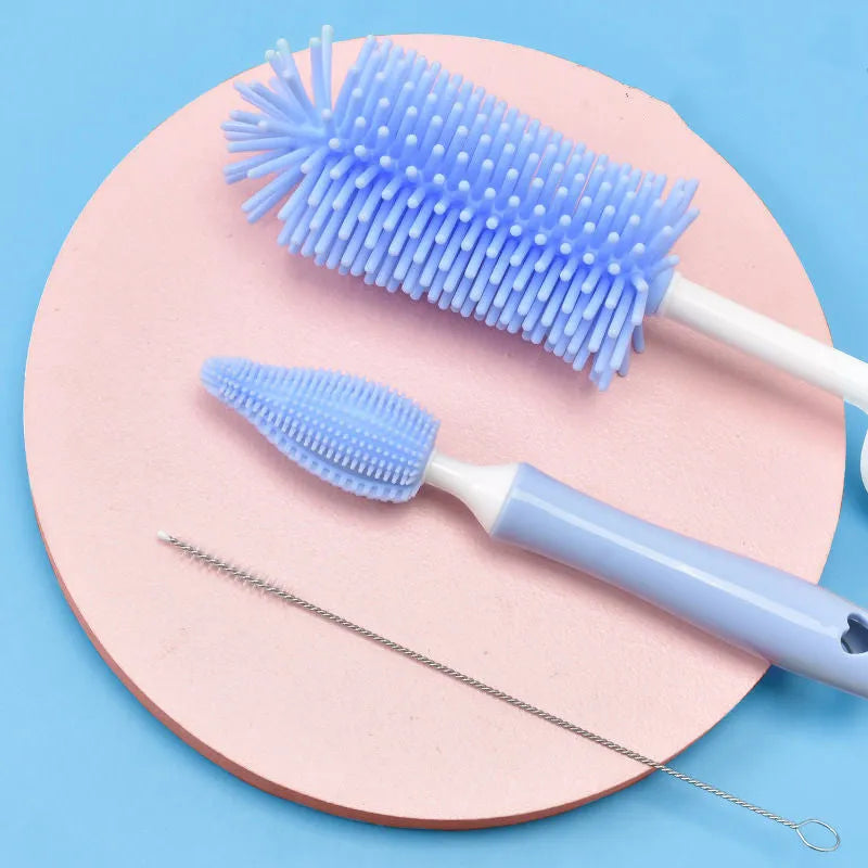 Silicone baby bottle brush set with main brush and separate straw cleaner in pink, blue and yellow colours.