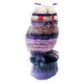 Hand-carved purple fluorite owl ornament on a neutral background, showing detailed carving and natural stone colour.