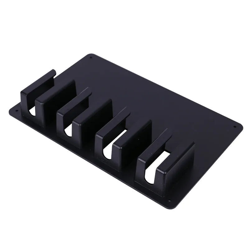 Black plastic wall-mounted frame for storing four electric hair clippers with included screws.
