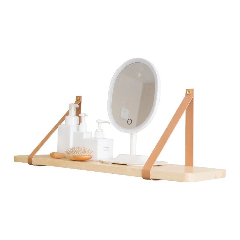 Solid pine wood wall mounted storage shelf in Nordic style, 50cm wide, holding remote controls and books.