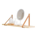 Solid pine wood wall mounted storage shelf in Nordic style, 50cm wide, holding remote controls and books.