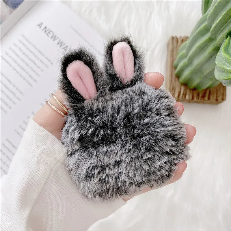 Pink rabbit ear silicone protective cover for Apple AirPods Pro case on a grey background.