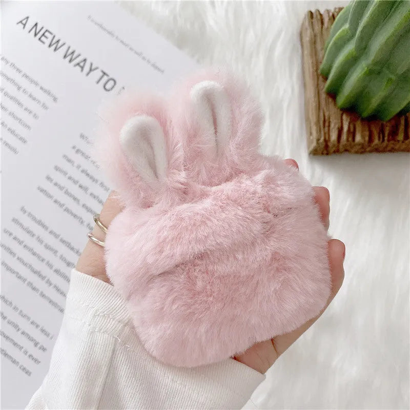 Pink rabbit ear silicone protective cover for Apple AirPods Pro case on a grey background.