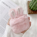 Pink rabbit ear silicone protective cover for Apple AirPods Pro case on a grey background.