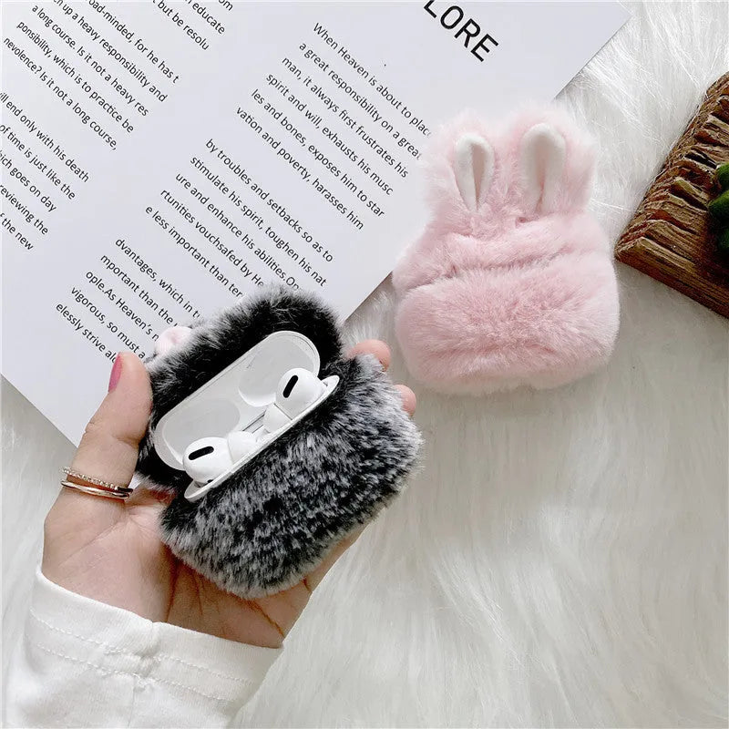 Pink rabbit ear silicone protective cover for Apple AirPods Pro case on a grey background.