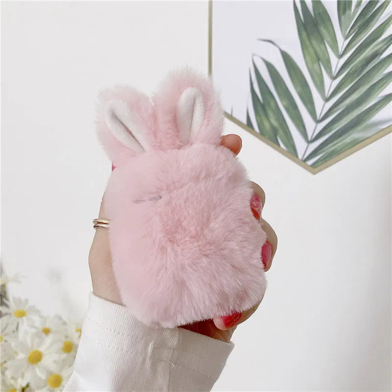 Pink rabbit ear silicone protective cover for Apple AirPods Pro case on a grey background.