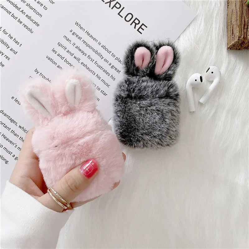 Pink rabbit ear silicone protective cover for Apple AirPods Pro case on a grey background.