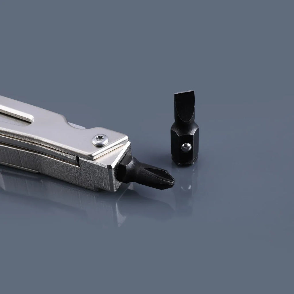 White stainless steel multi-tool with wrench, knife blade, and needle-nose pliers on a plain background.