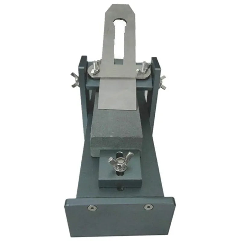 Fixed angle woodworking sharpener for chisels, planers and carving knives on a workbench.