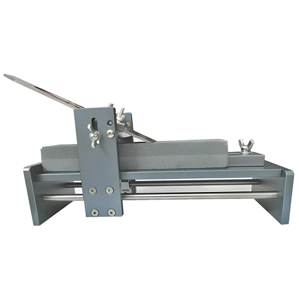 Fixed angle woodworking sharpener for chisels, planers and carving knives on a workbench.