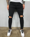 Men's stretch skinny ripped jeans in dark blue with knee hole detail, front view