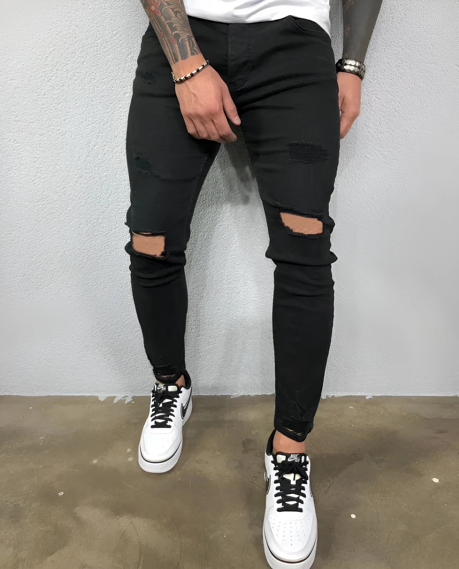 Men's stretch skinny ripped jeans in dark blue with knee hole detail, front view