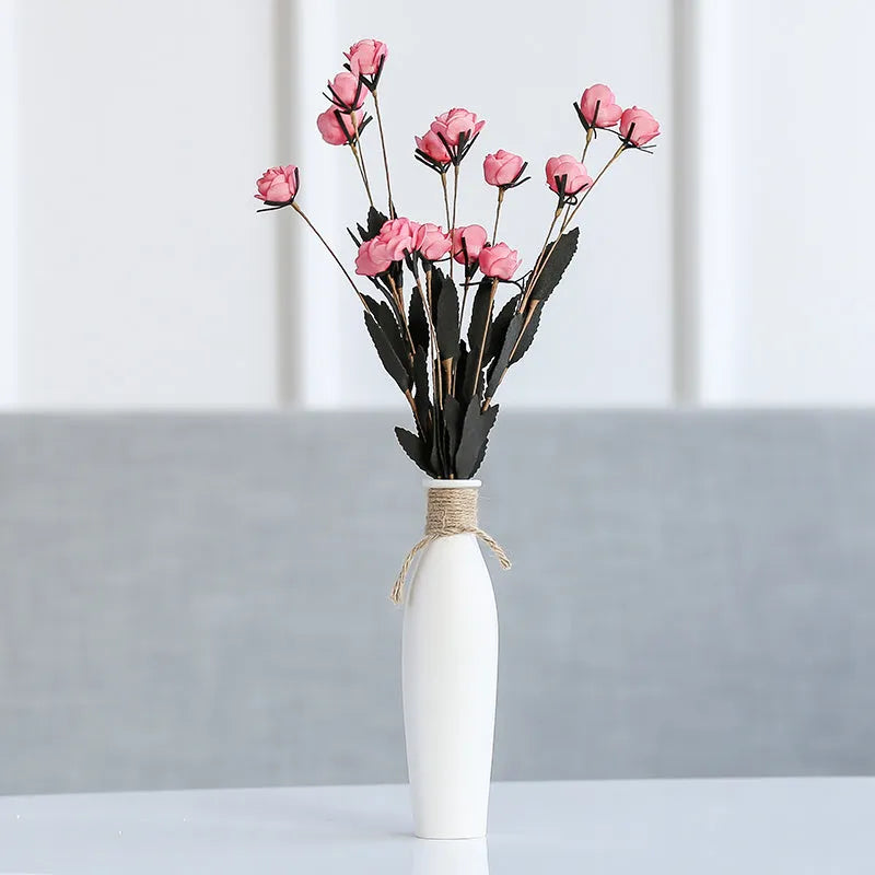 Modern simple ceramic vase with artificial dried flower arrangement on a countertop, medium size