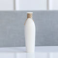 Modern simple ceramic vase with artificial dried flower arrangement on a countertop, medium size
