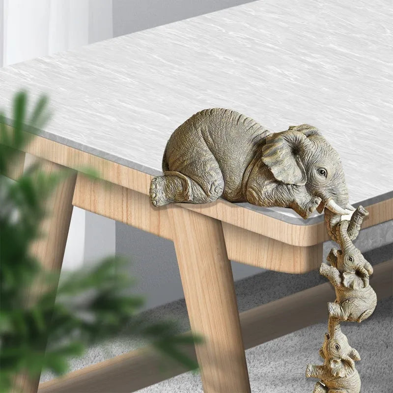 Resin mother elephant and baby elephant figurine set on display