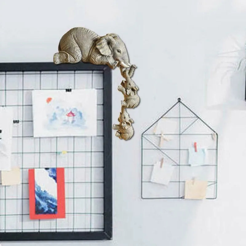 Resin mother elephant and baby elephant figurine set on display