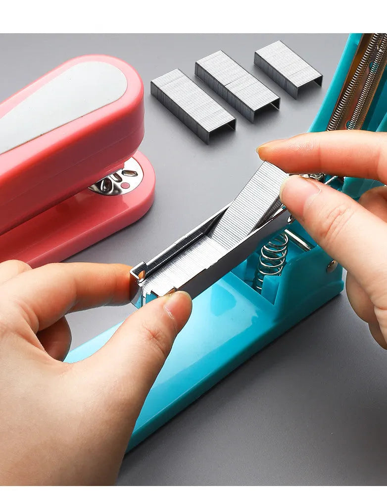 360-degree rotatable stapler in dark blue on a desk with papers, showing swivel head movement.