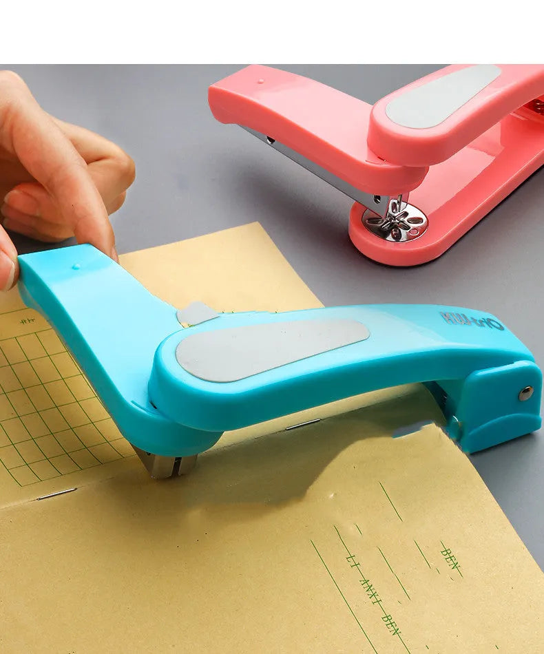 360-degree rotatable stapler in dark blue on a desk with papers, showing swivel head movement.