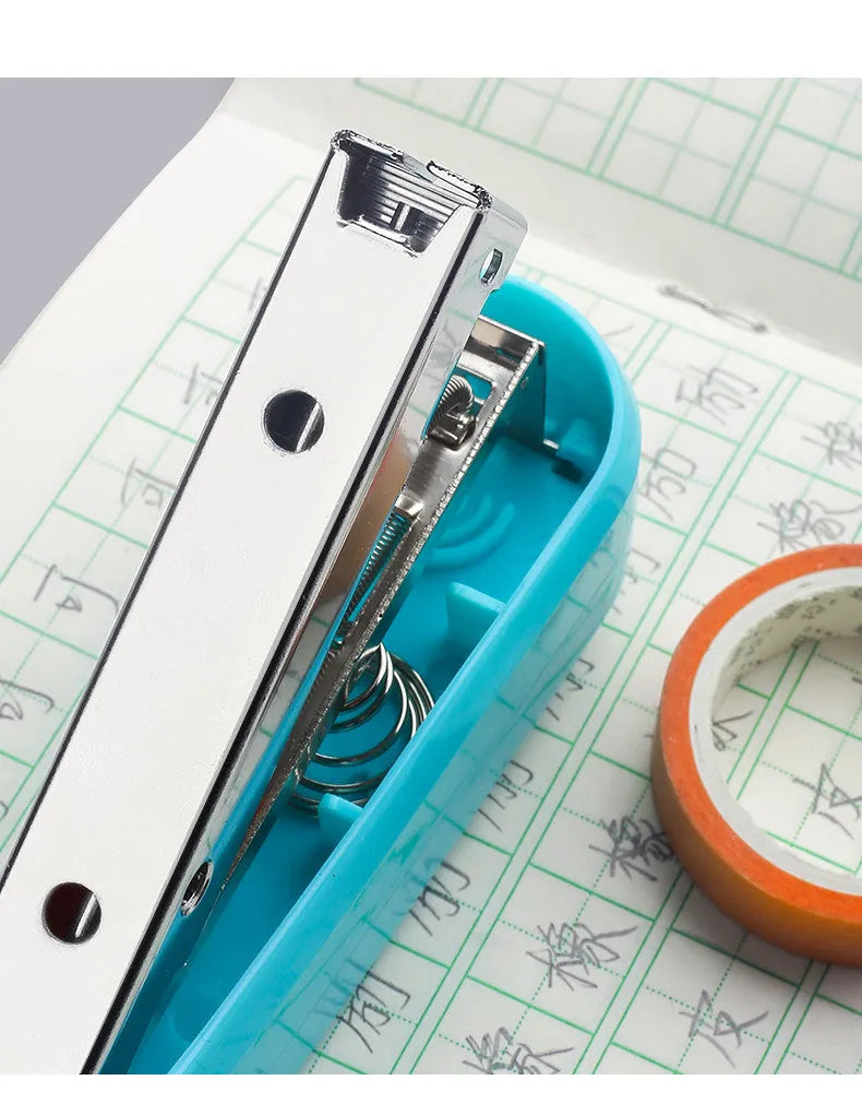 360-degree rotatable stapler in dark blue on a desk with papers, showing swivel head movement.