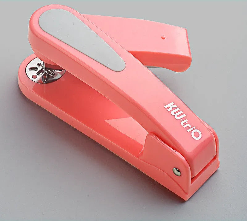 360-degree rotatable stapler in dark blue on a desk with papers, showing swivel head movement.