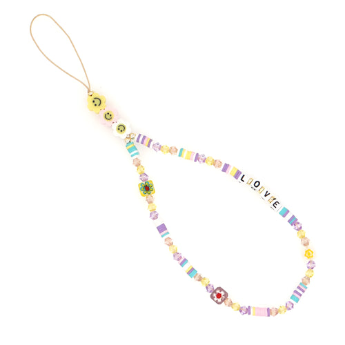 Handmade bohemian smiley soft ceramic beaded phone chain with crystal and acrylic letter beads on a light background