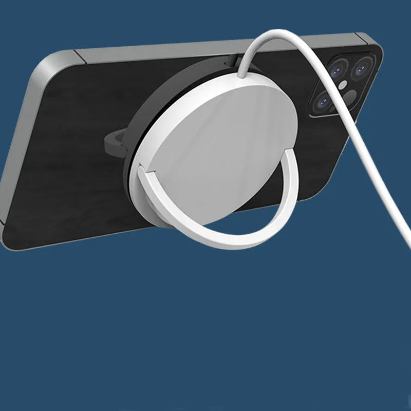 Black magnetic car phone holder with wireless charging showing phone attachment