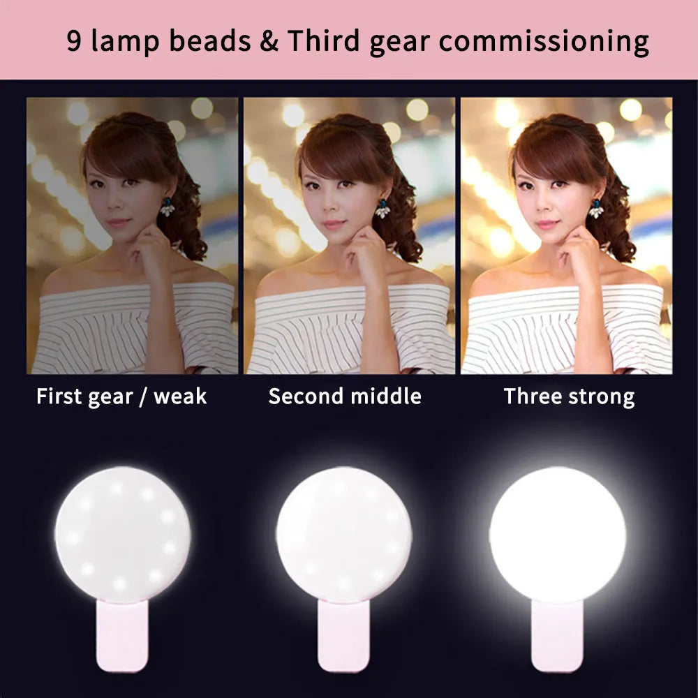 White round clip-on mini fill light attached to a mobile phone for selfies.