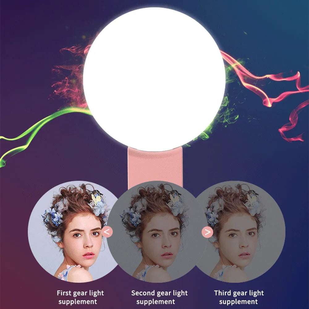White round clip-on mini fill light attached to a mobile phone for selfies.