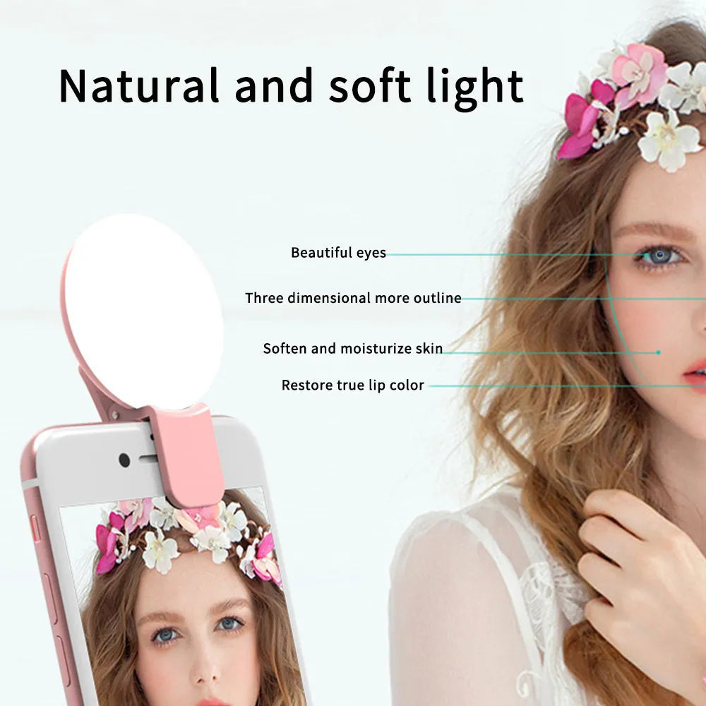 White round clip-on mini fill light attached to a mobile phone for selfies.