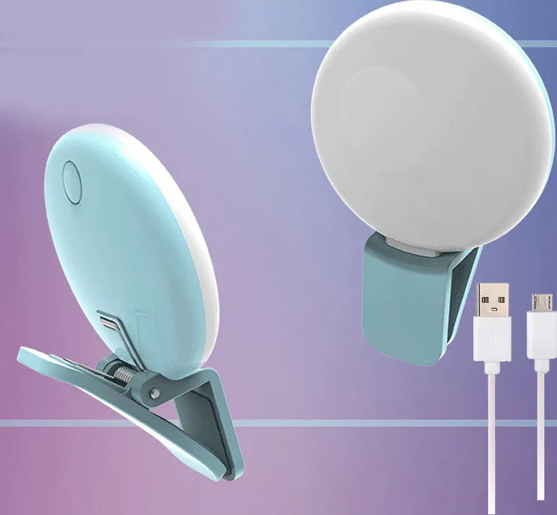 White round clip-on mini fill light attached to a mobile phone for selfies.