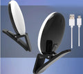 White round clip-on mini fill light attached to a mobile phone for selfies.