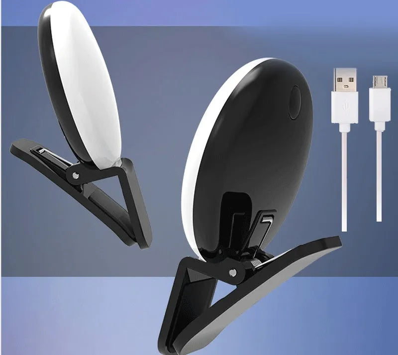 White round clip-on mini fill light attached to a mobile phone for selfies.