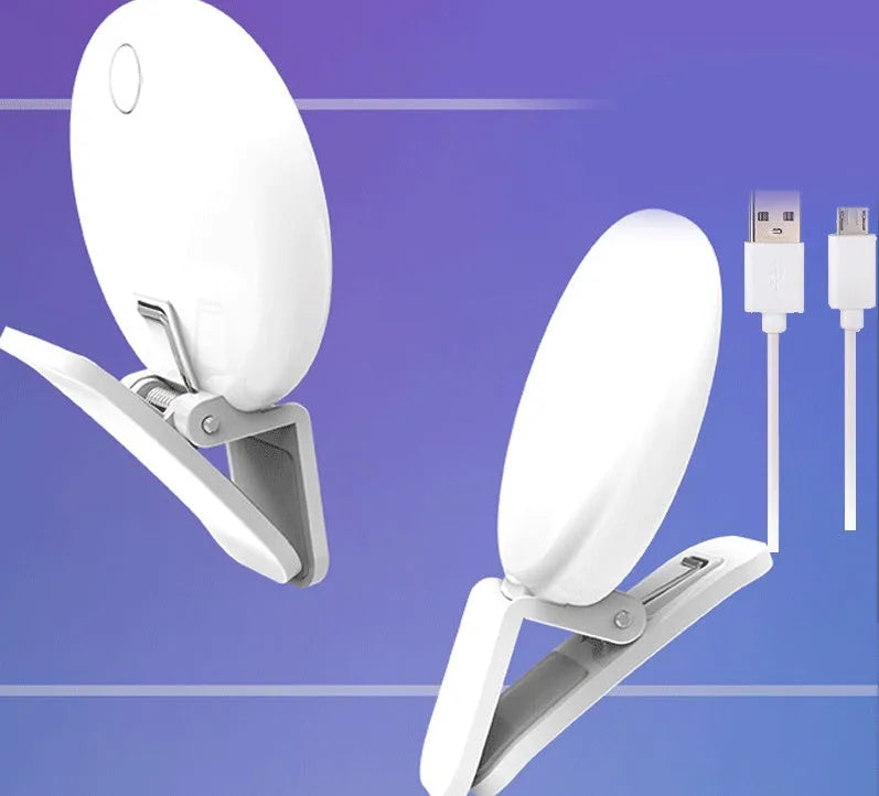 White round clip-on mini fill light attached to a mobile phone for selfies.