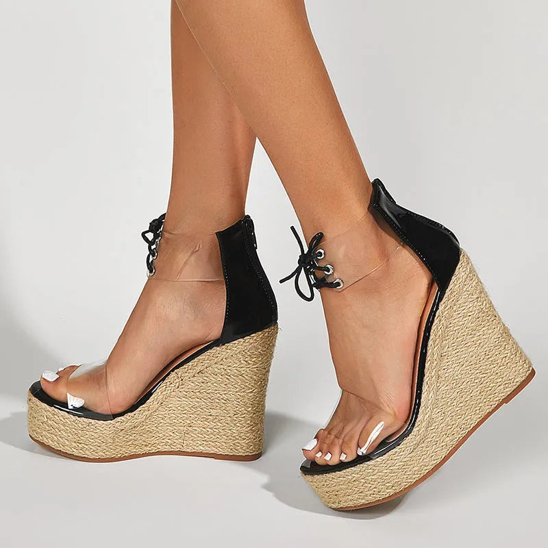 Black women's wedge sandals with hemp rope detail on the upper and a high platform sole, showing front tie closure.