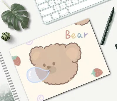 Cartoon character mouse pad on a desk, showing a colourful printed design with an anti-slip rubber base.
