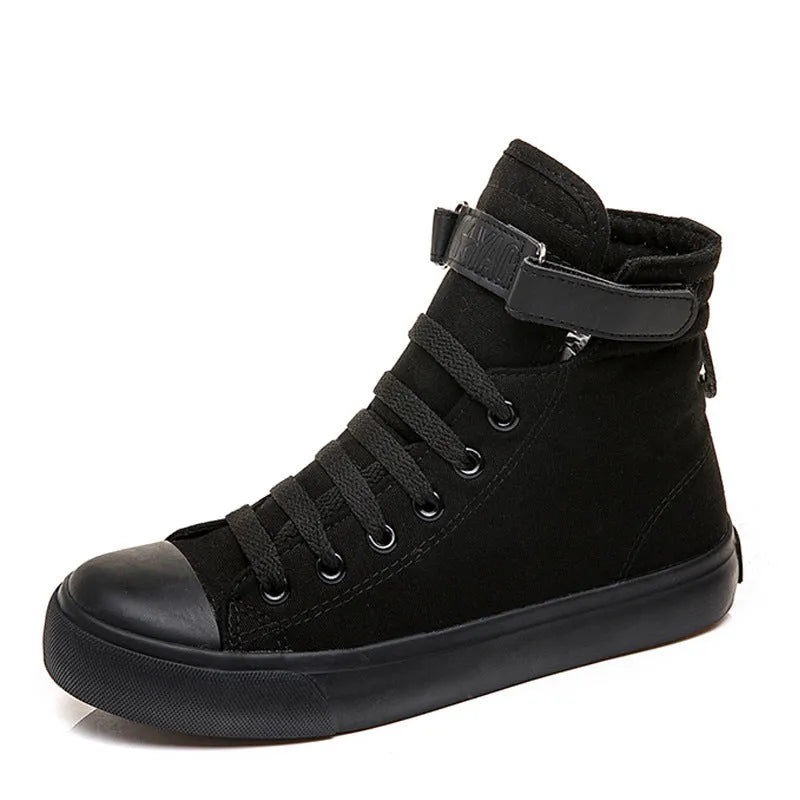 Pair of women's high-top canvas shoes with Velcro strap, black colour, rubber sole on a light background