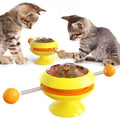 Rotatable interactive cat toy with catnip balls inside a transparent top and a large suction cup base, shown in lake blue.