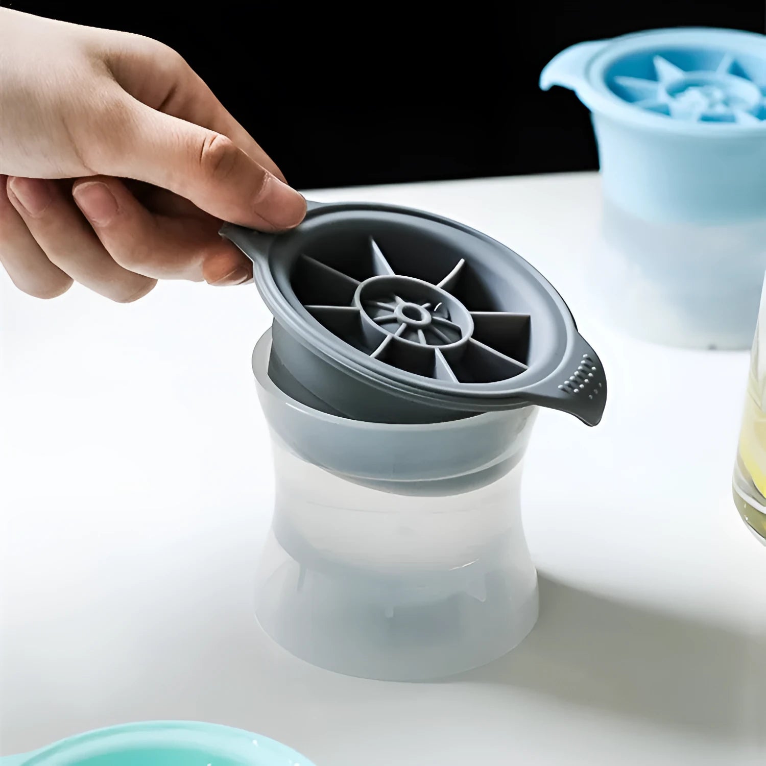 Flexible silicone ice tray for making large ice hockey shapes and spherical or pentagonal ice cubes in various colours