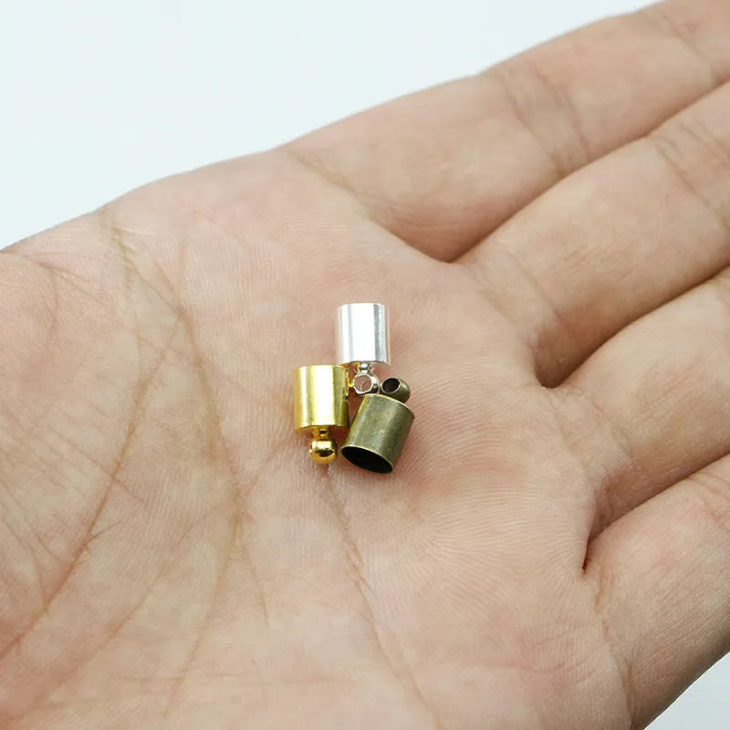 Assortment of multi-colour electroplated copper weight caps and bell caps in various sizes for crafting.