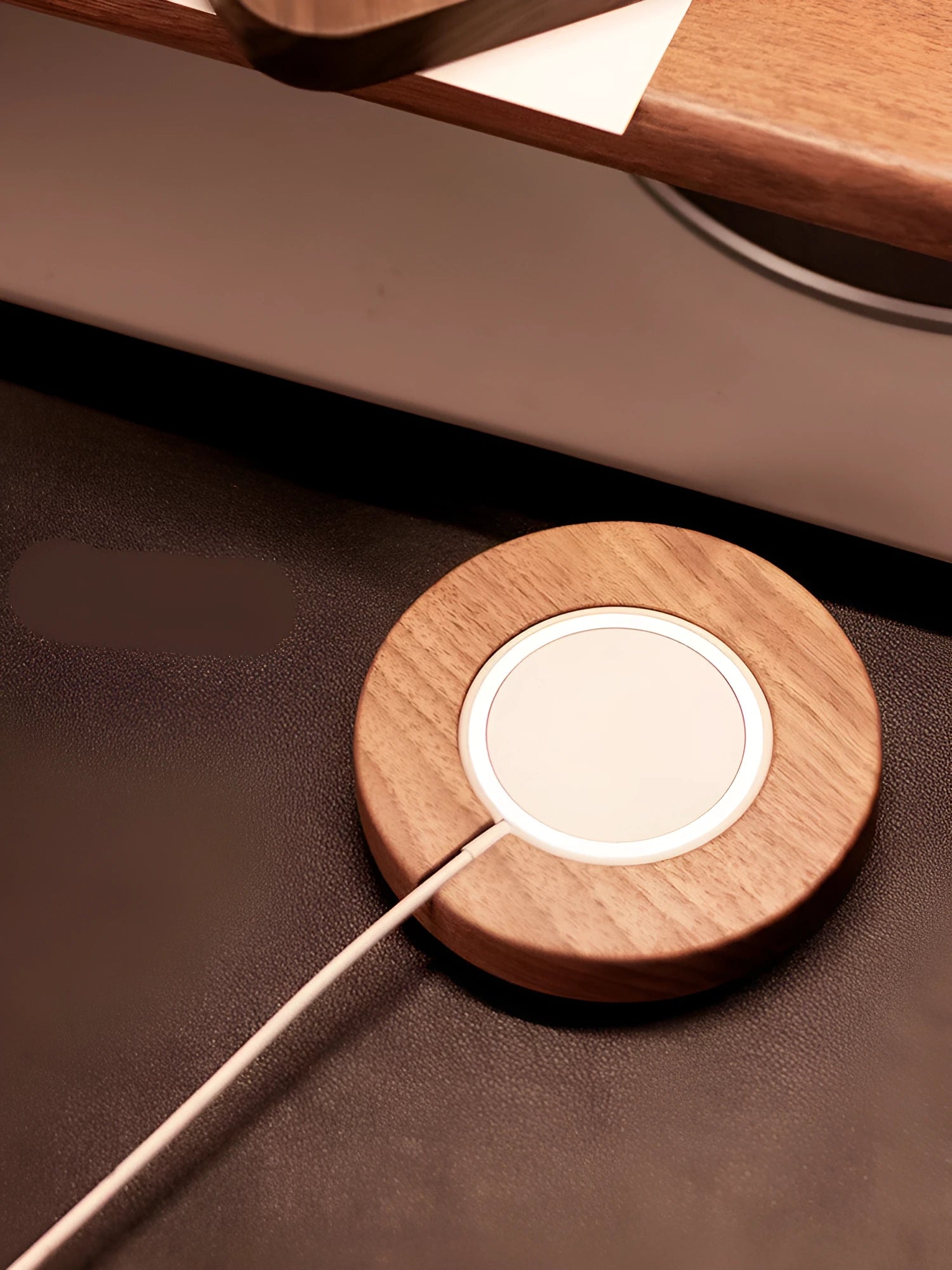 Walnut solid wood magnetic wireless charger bracket on desktop with phone attached