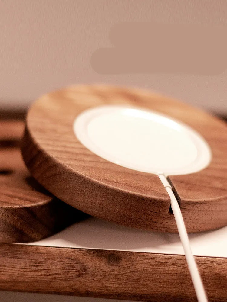 Walnut solid wood magnetic wireless charger bracket on desktop with phone attached