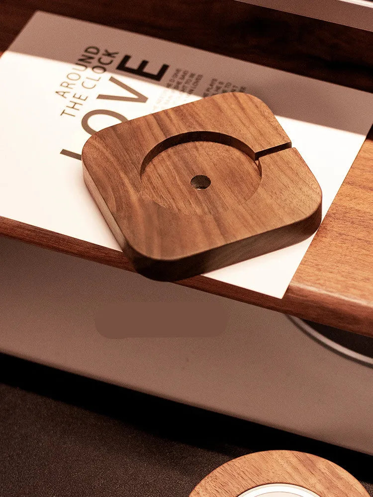 Walnut solid wood magnetic wireless charger bracket on desktop with phone attached