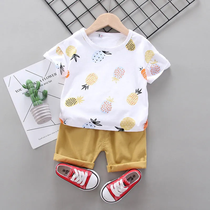 White cotton short-sleeve summer suit set for boys and girls with cartoon print, flat lay
