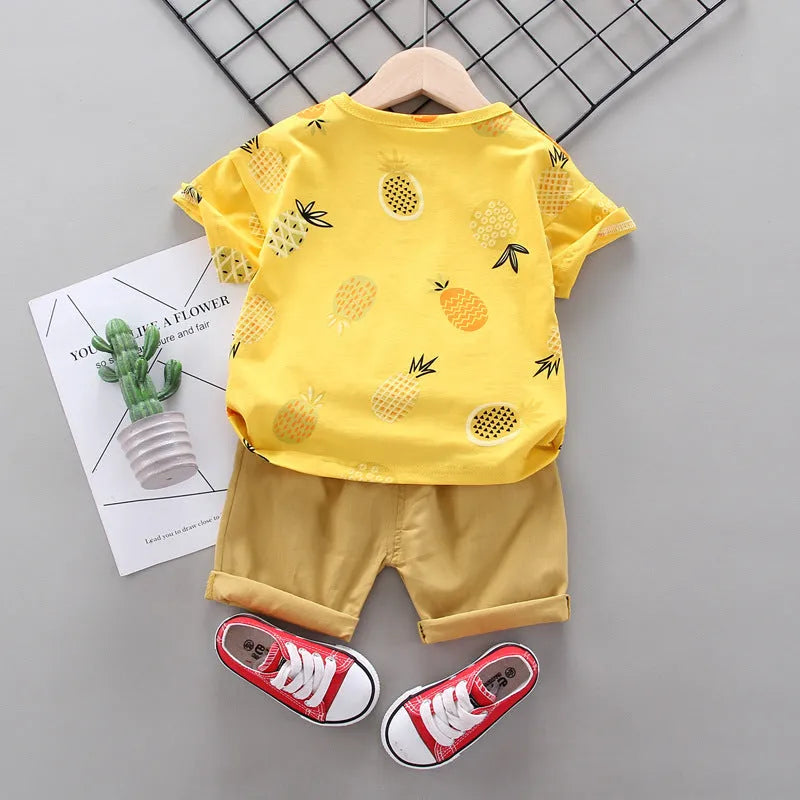 White cotton short-sleeve summer suit set for boys and girls with cartoon print, flat lay