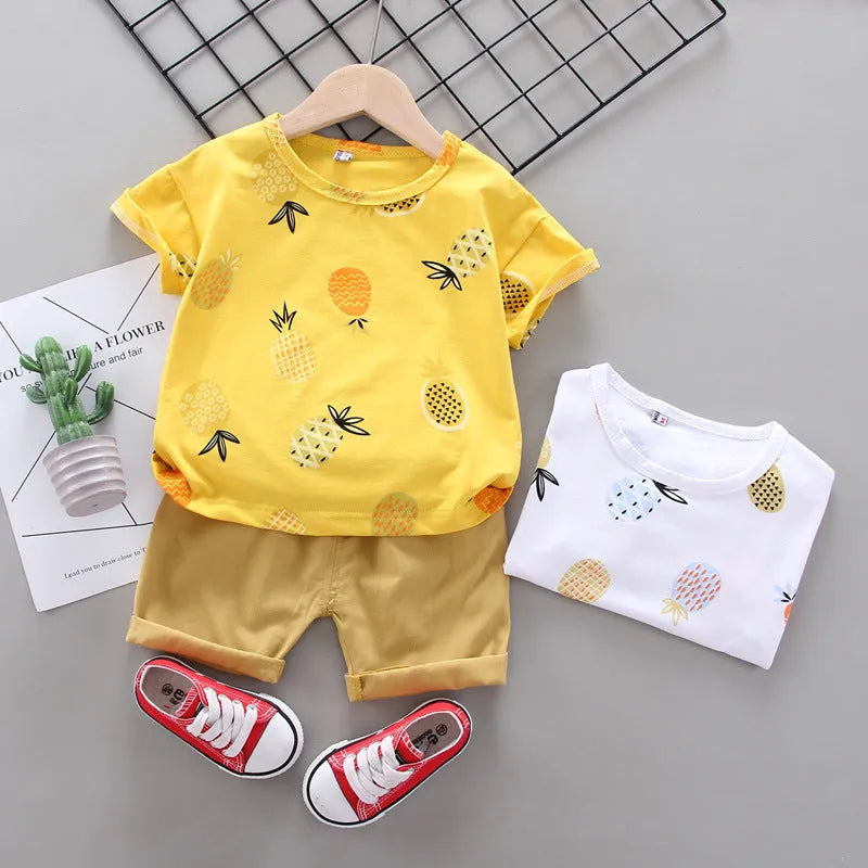 White cotton short-sleeve summer suit set for boys and girls with cartoon print, flat lay