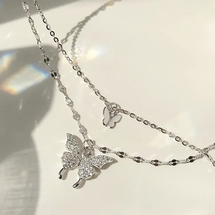 Silver colour double layer clavicle chain necklace with shiny butterfly pendant on copper base